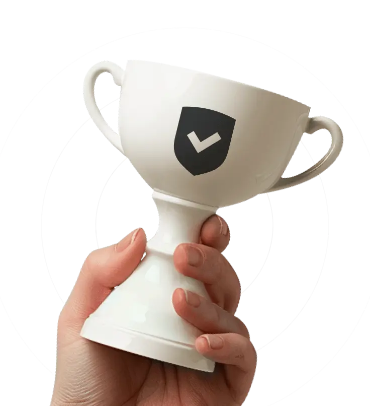 A hand holding a white chalice with a checkmarked shield on it.