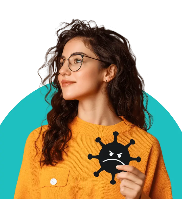 A woman with curly brown hair and glasses in an orange jumper holding an illustrated virus with an angry face on it.